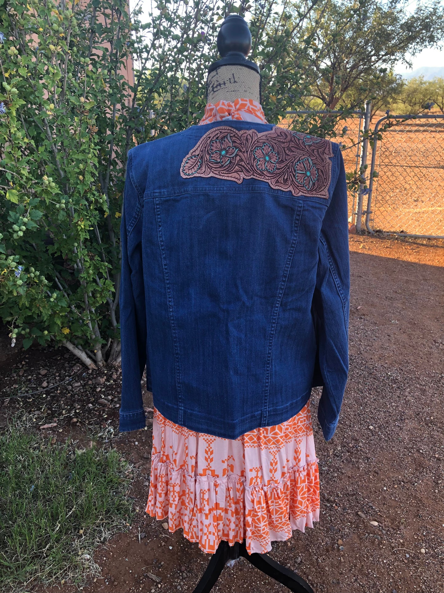 Women’s western tooled leather floral collarless denim jacket