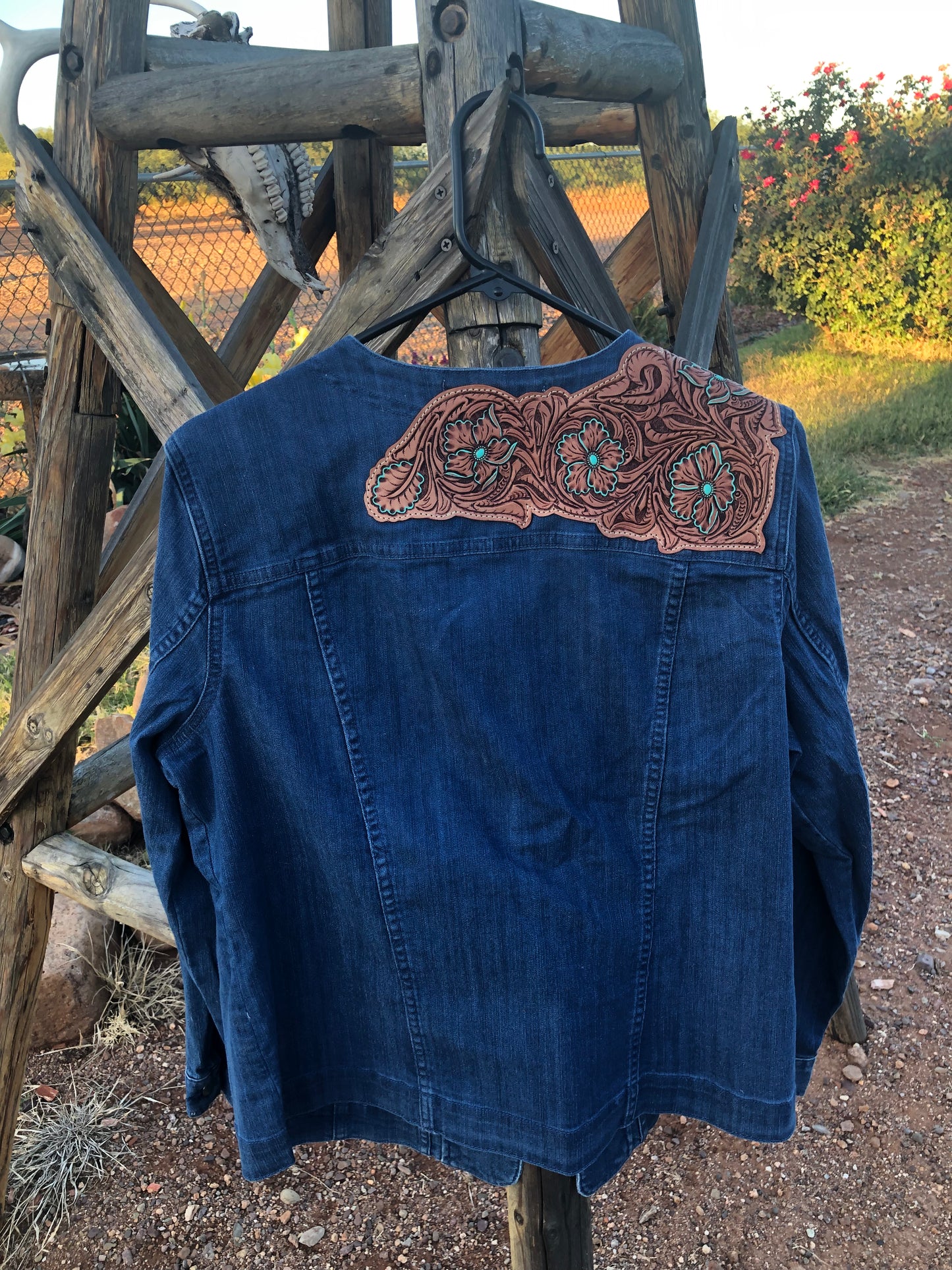 Women’s western tooled leather floral collarless denim jacket