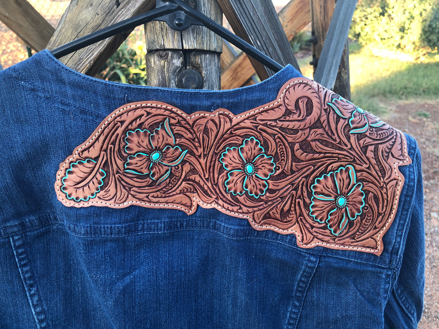 Women’s western tooled leather floral collarless denim jacket