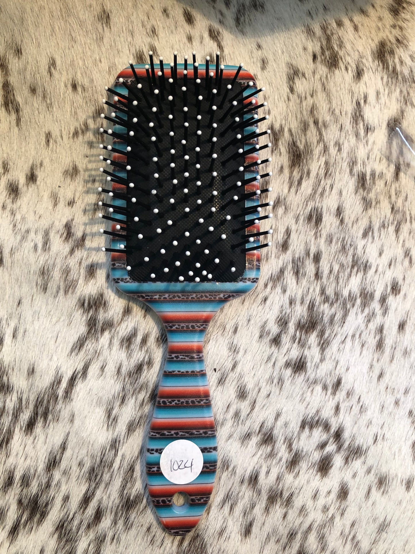 Western tooled leather floral and turquoise butterfly patch on serape print paddle brush