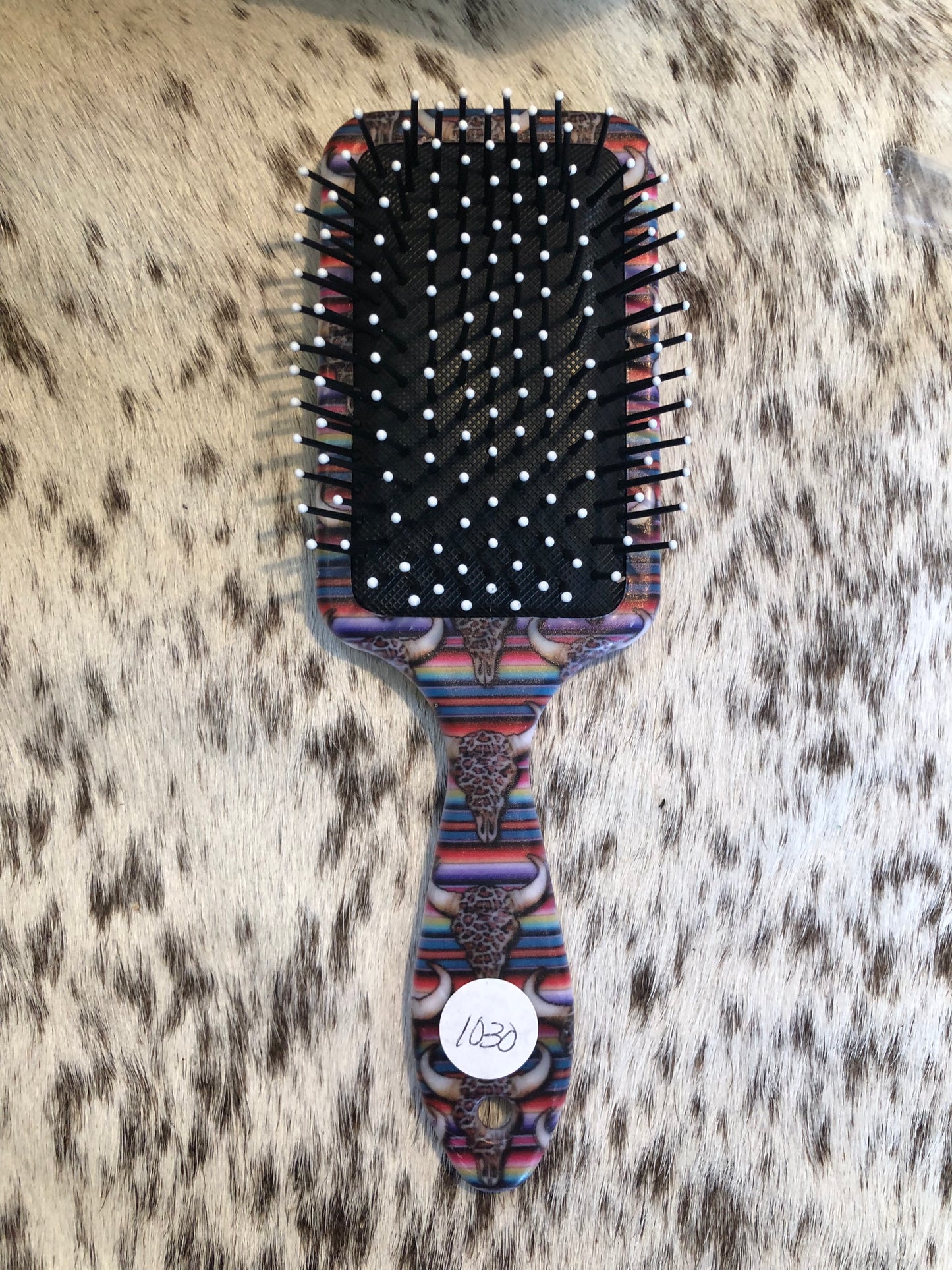 Western tooled leather floral and faux beadwork patch on serape and leopard print cow skull print paddle brush