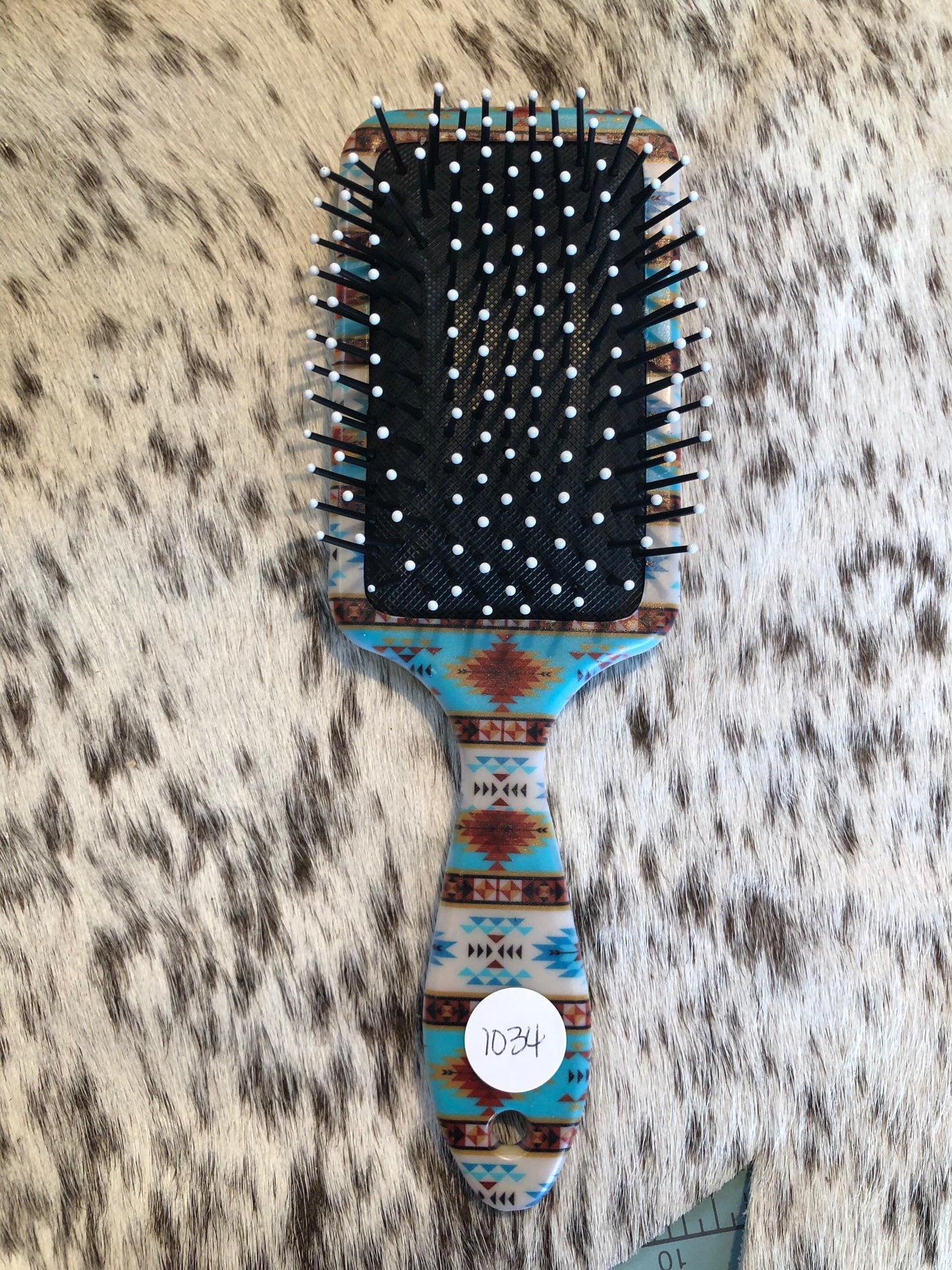 Western tooled leather floral patch on southwestern print paddle brush