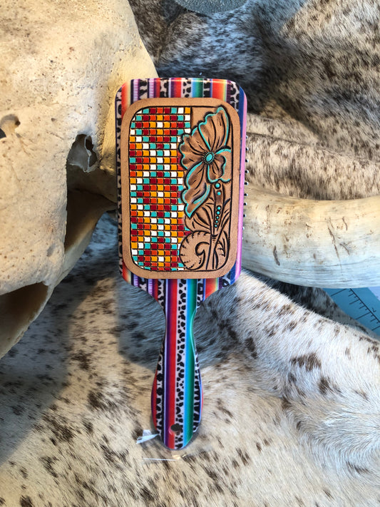 Western tooled leather floral and faux beadwork patch on serape print paddle brush