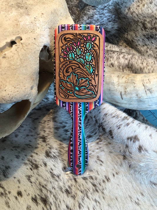 Southwestern tooled leather floral and prickly pear patch on serape print paddle brush