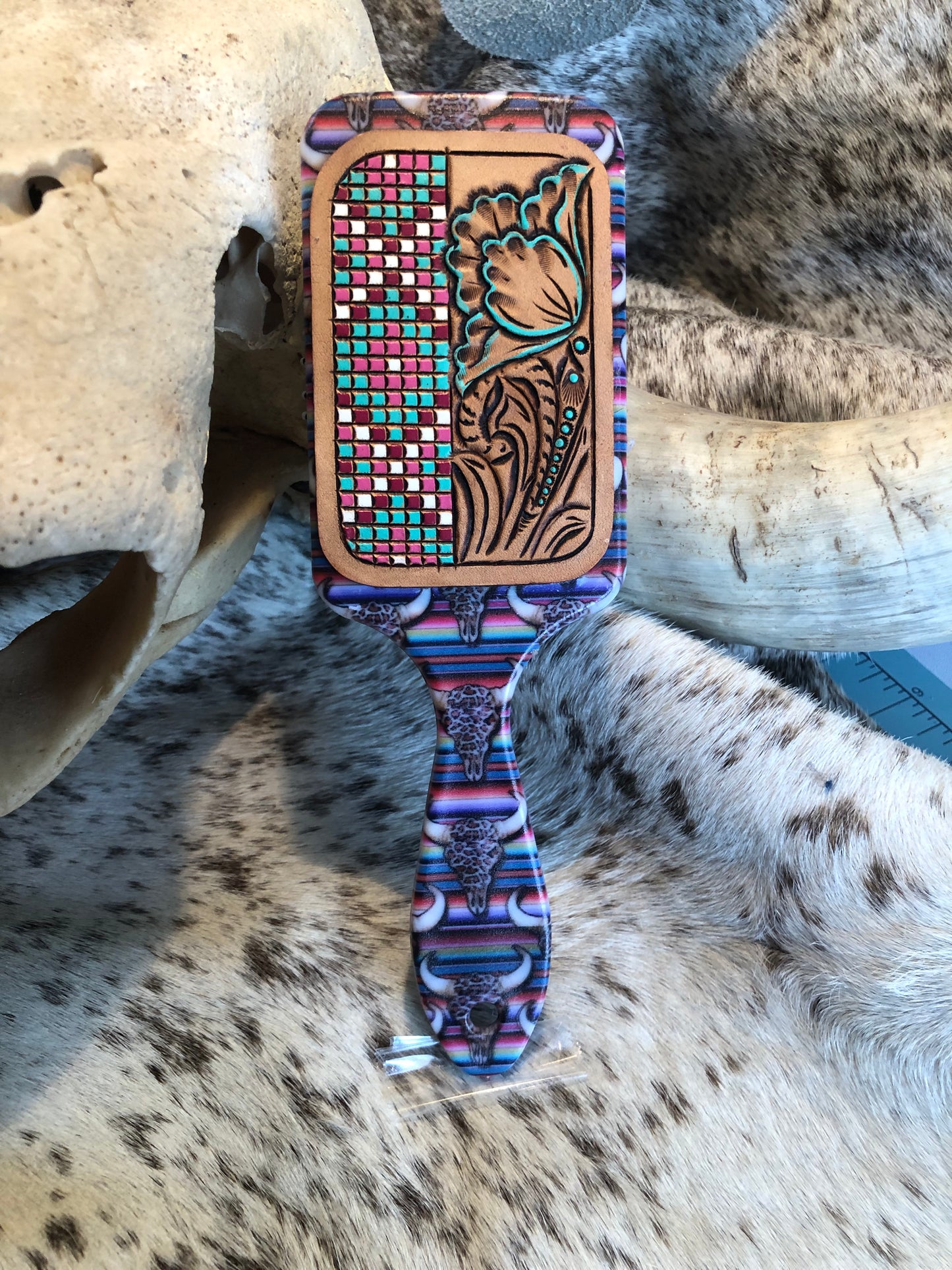 Western tooled leather floral and faux beadwork patch on serape and leopard print cow skull print paddle brush