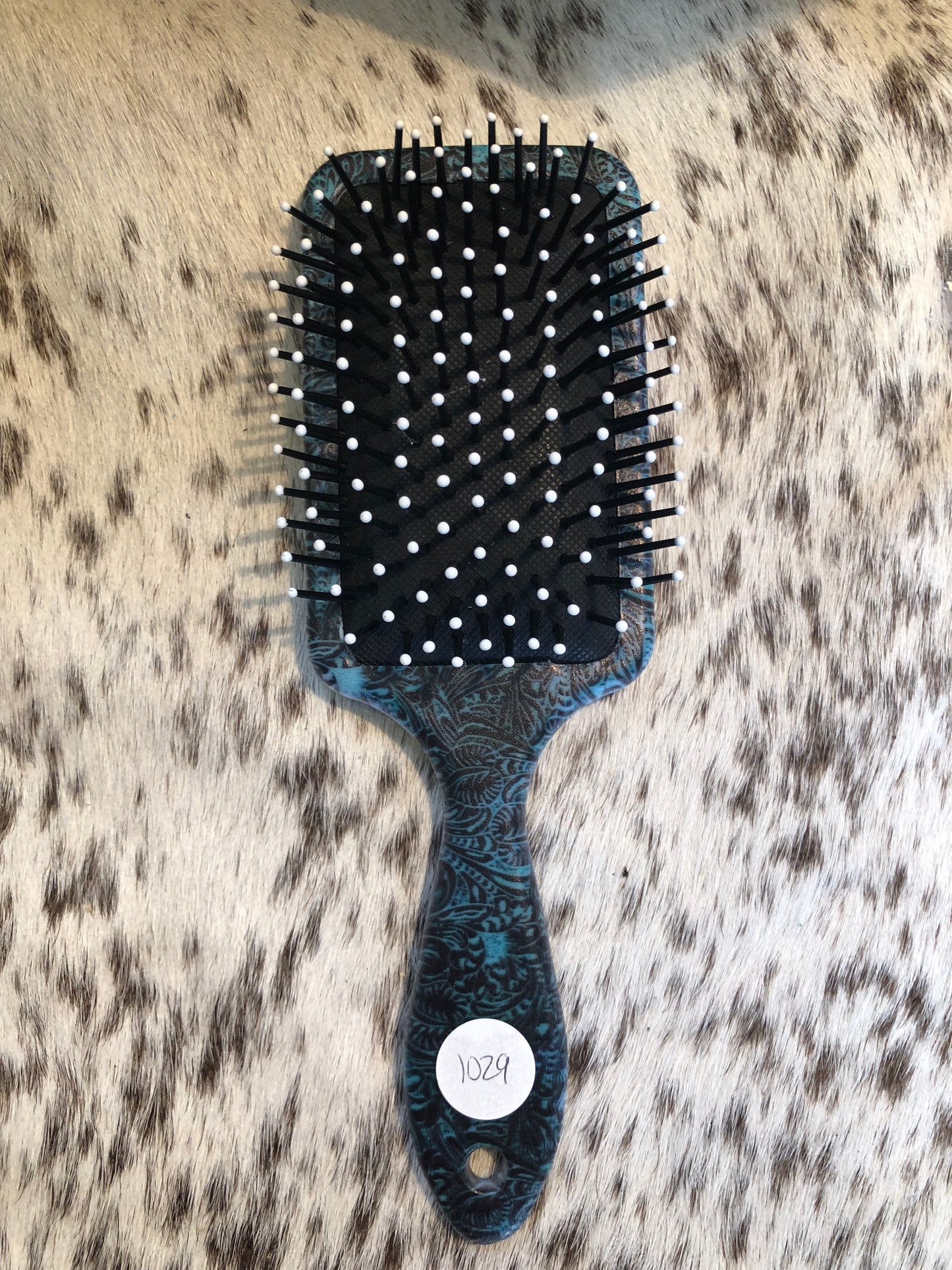 Western tooled leather sunflower patch on turquoise paisley print paddle brush