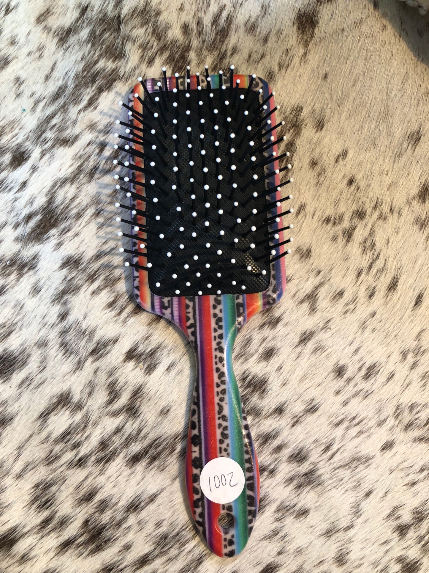 Western tooled leather floral and faux beadwork patch on serape print paddle brush