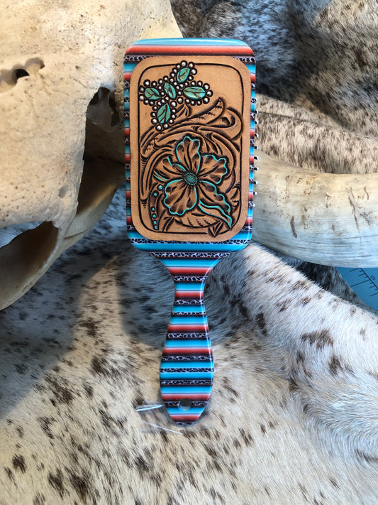 Western tooled leather floral and turquoise butterfly patch on serape print paddle brush