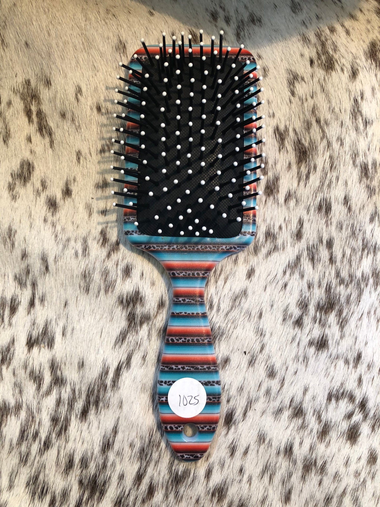 Western tooled leather floral and turquoise butterfly patch on serape print paddle brush