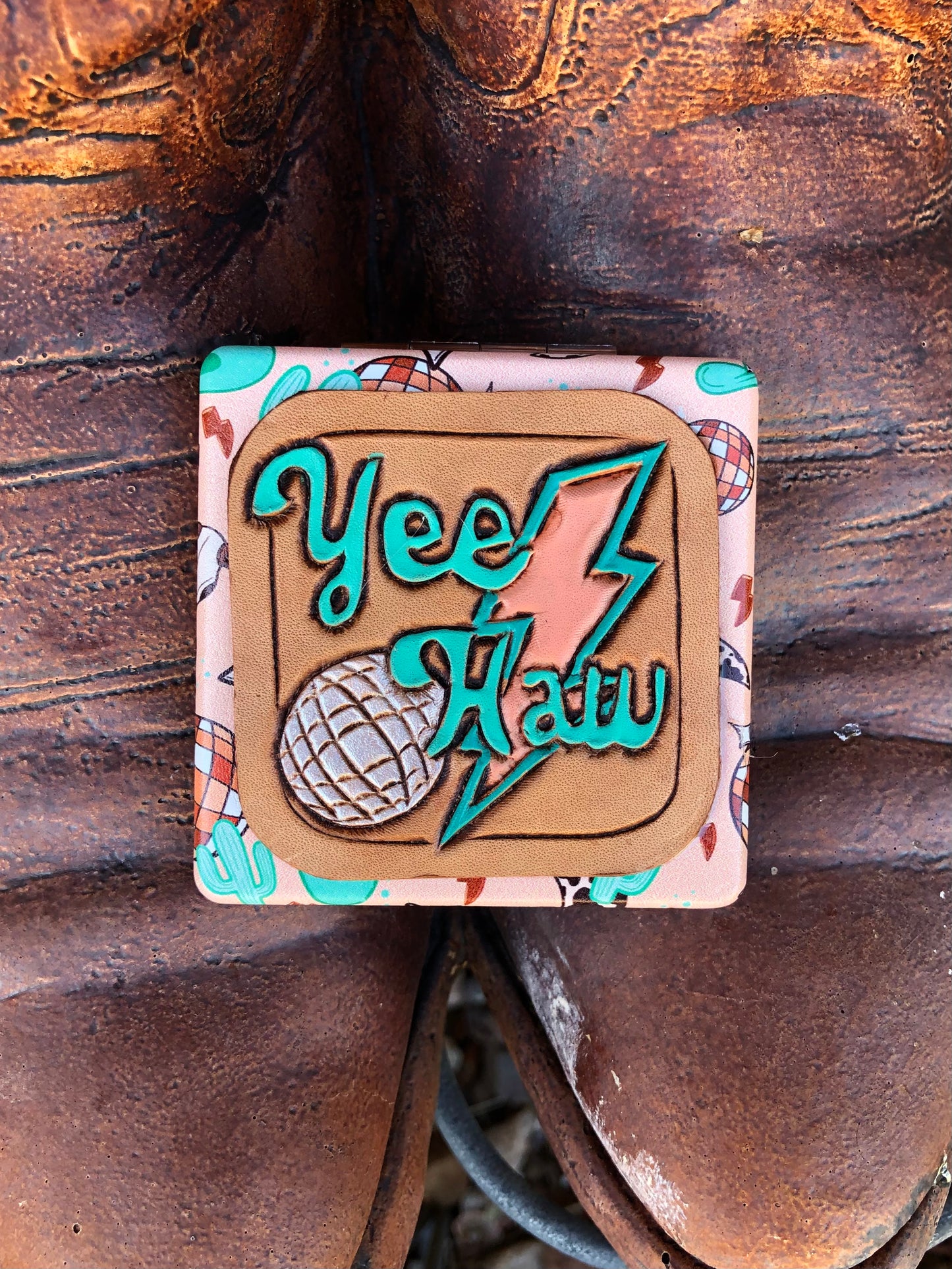 Western tooled leather YeeHaw patch on peachy cow skull and disco ball compact