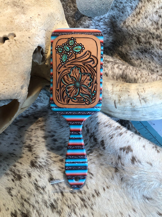 Western tooled leather floral and turquoise butterfly patch on serape print paddle brush