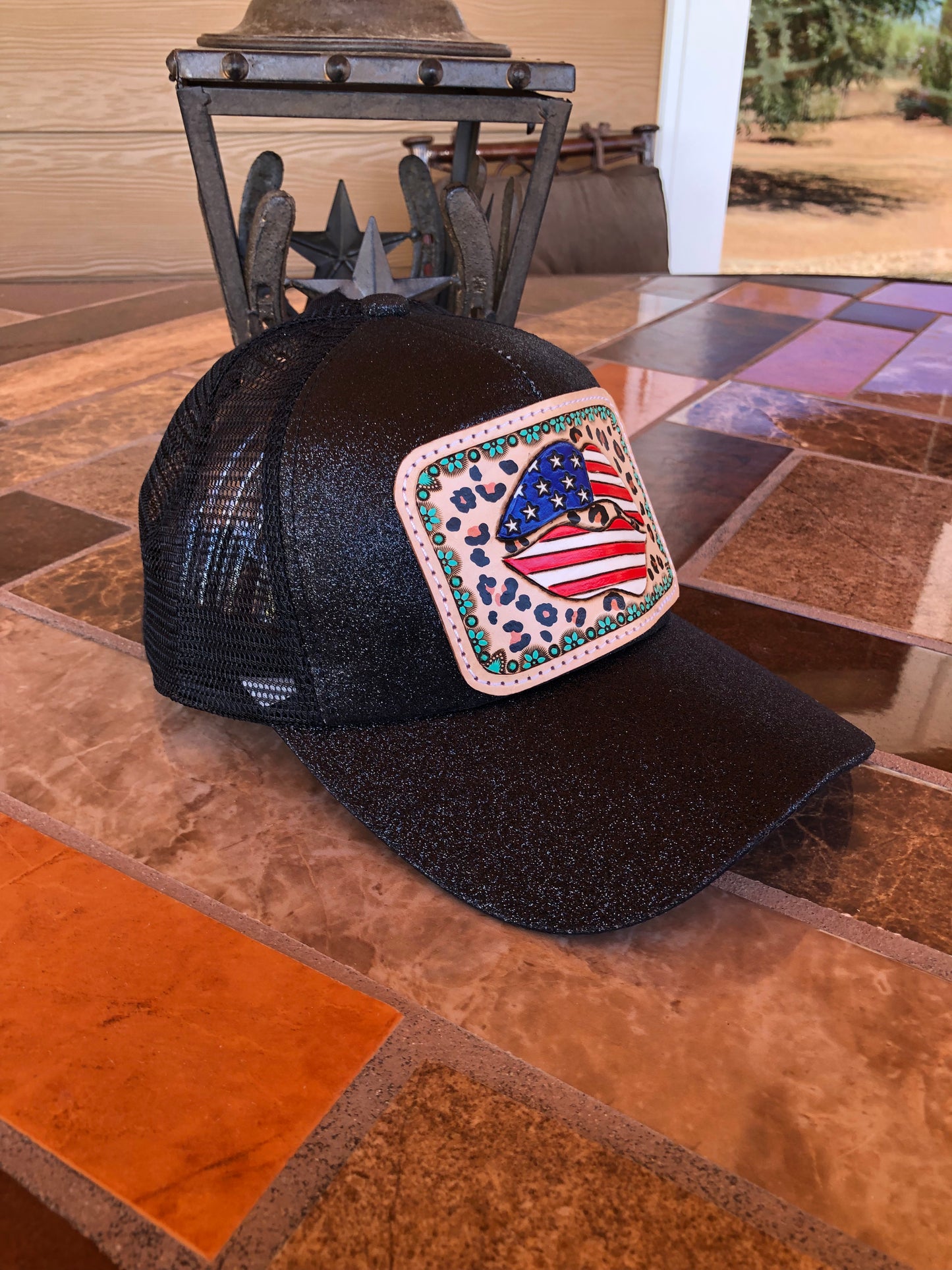 Women’s tooled leather patriotic lips and leopard print patch black glitter ponytail trucker cap