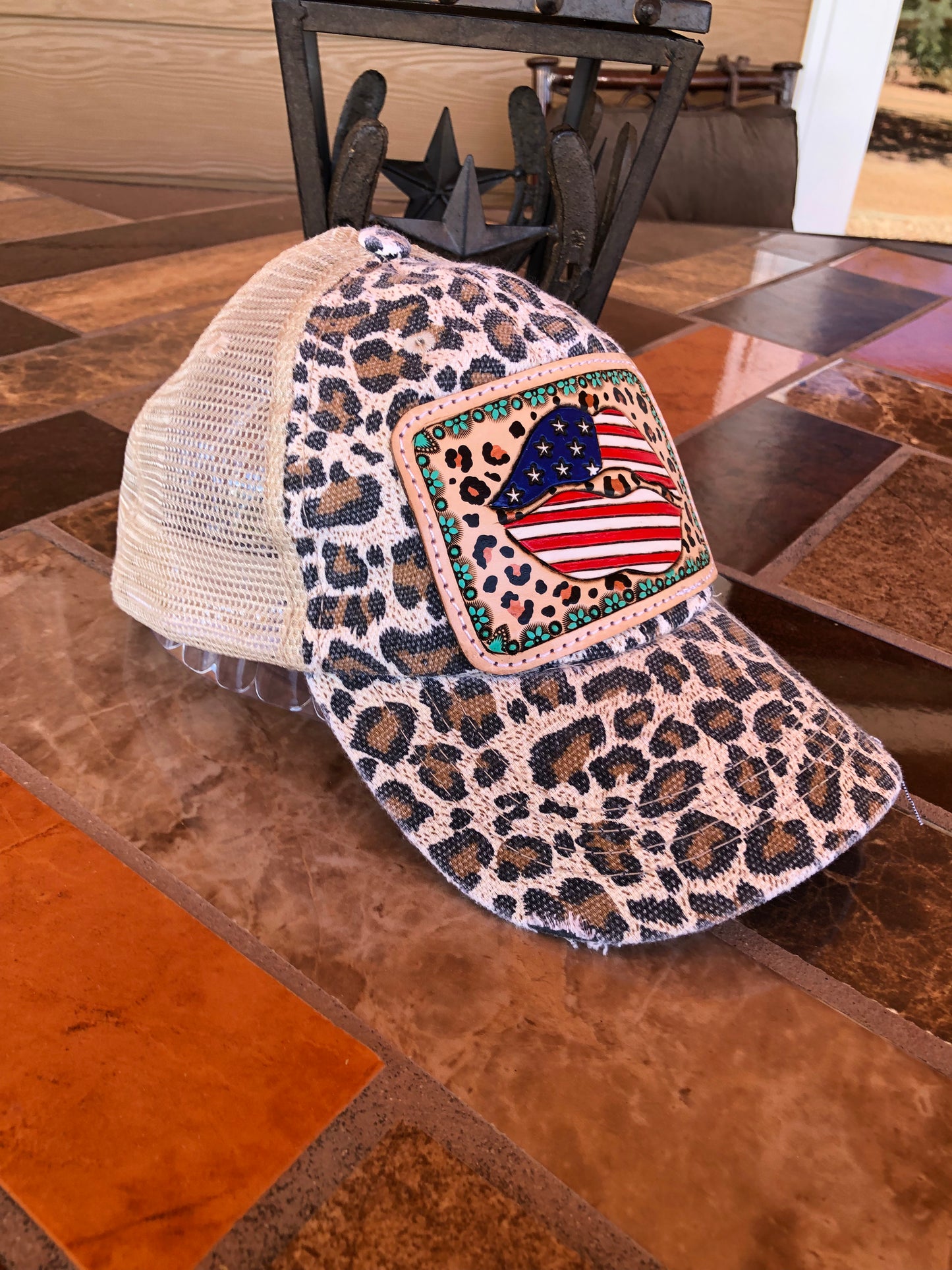 Women’s tooled leather patriotic lips and leopard print patch leopard print trucker cap