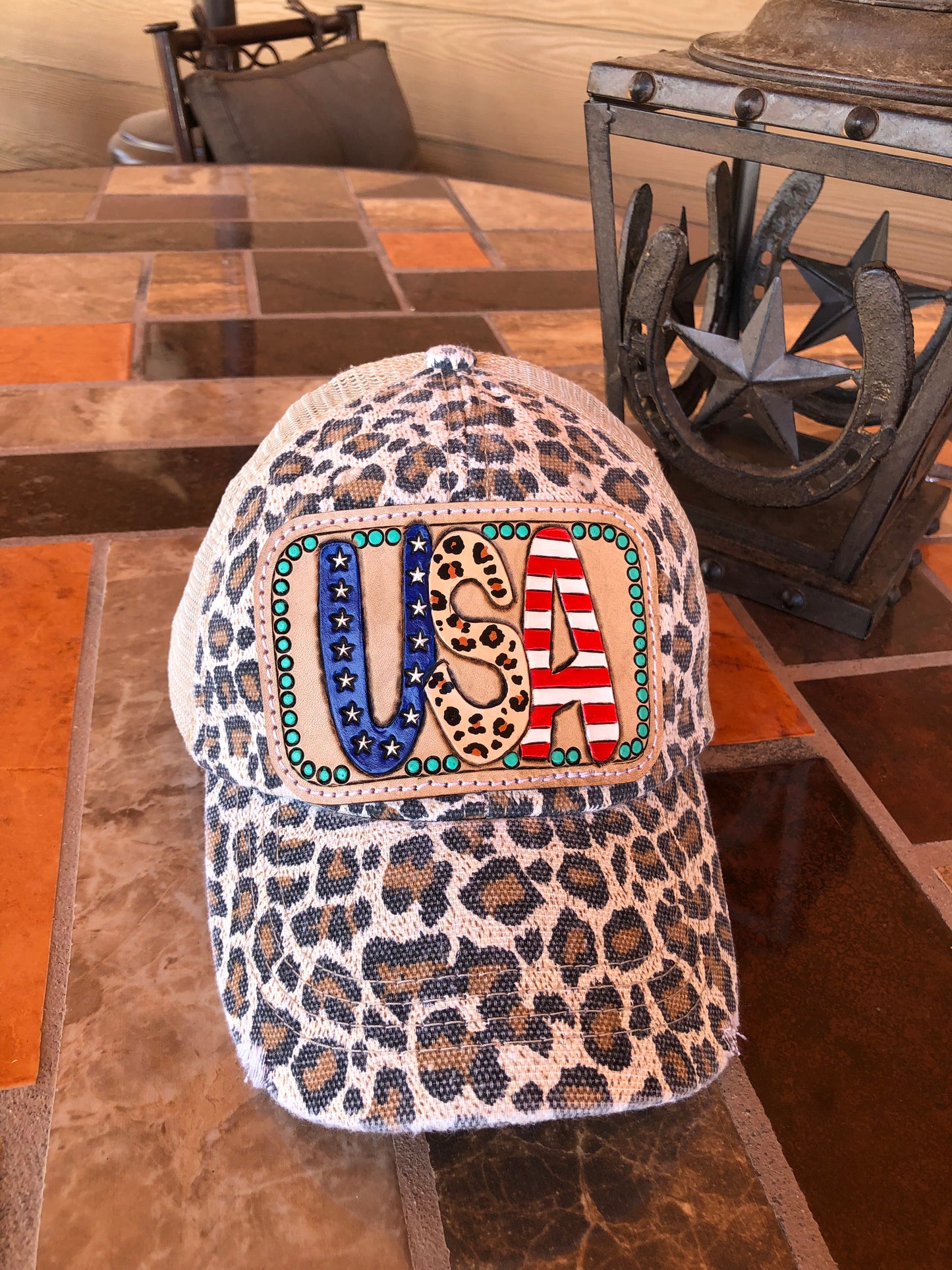 Women’s tooled leather patriotic USA patch leopard print trucker cap