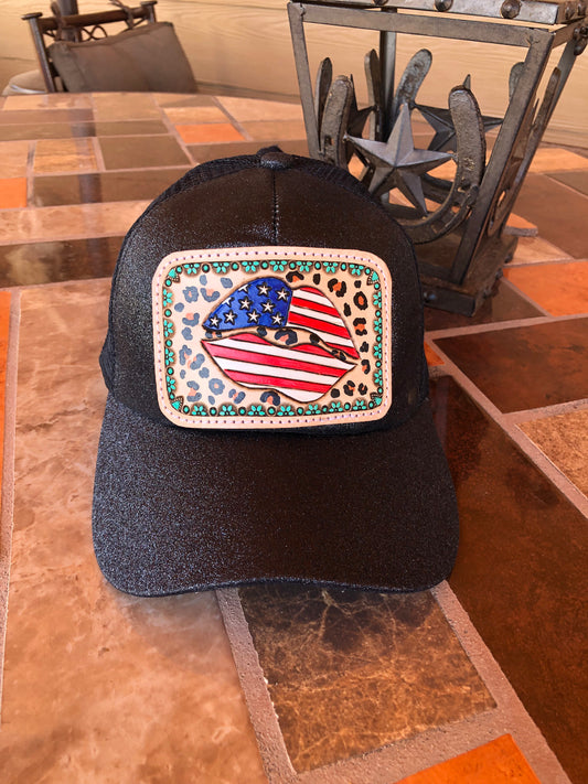 Women’s tooled leather patriotic lips and leopard print patch black glitter ponytail trucker cap